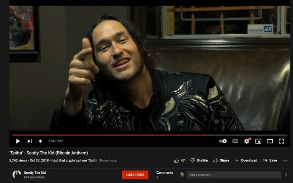 Figure 4. A screenshot from a YouTube music video for Rojas’s rap song, “Spitta,” which the video title describes as a “Bitcoin Anthem.” Archived on Perma.cc, https://perma.cc/W2YP-4VYY. Credit: TaSC.